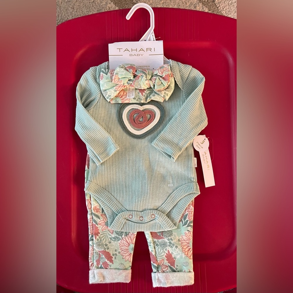 Waffle onesie with long sleeves and floral long pants with a bow headband.
